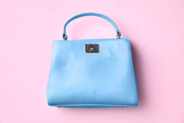 istock Stylish small women's bag on pink background, top view 1384269466