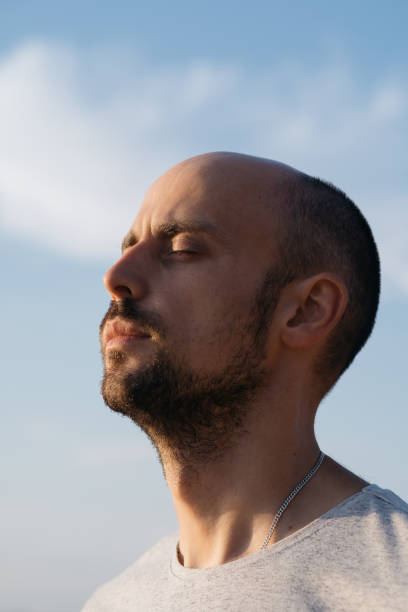 istock young man enjoying a warm summer day. close-up 1384269568