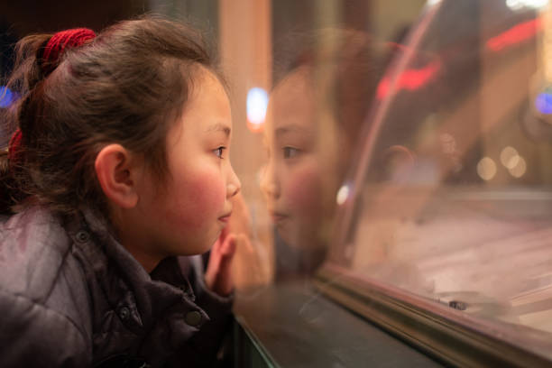 istock Girl looking at the show window 1384272267