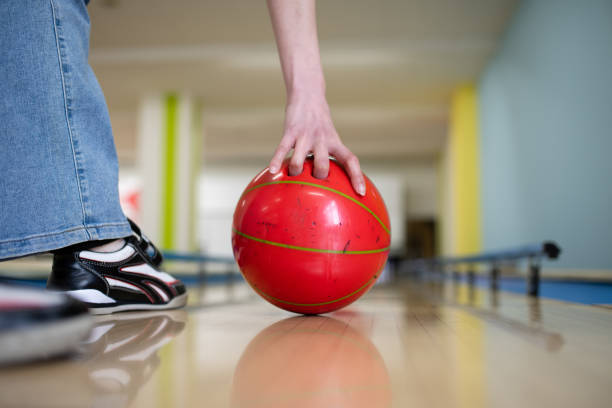 Group of friends hanging out at vintage bowling alley. All dressed in casual clothes. Interior of vintage bowling alley  in Toronto, Canada.