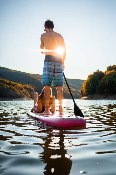 istock Adventurous young couple paddleboarding on a warm summer day 1384272935