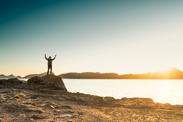 istock Man exploring the coast line at sunset 1384275845