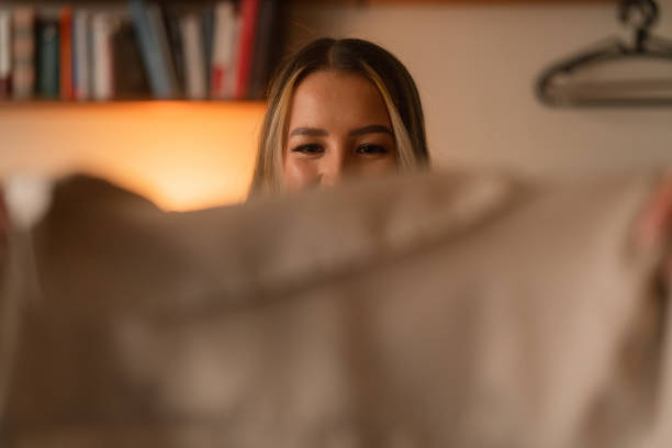 istock Woman choosing clothes to pack for a trip 1384277304