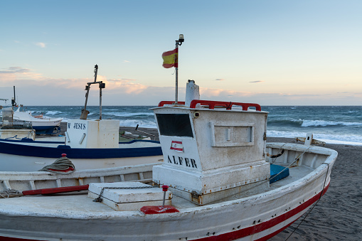 Cabo de Gata, Spain - 3 March, 2022: colorful fishing boats on the beach in Cabo de Gata at twilight