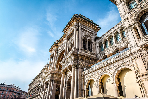 Galleria Vittorio Emanuele II Entrance Under Blue Sky In Milan, Italy