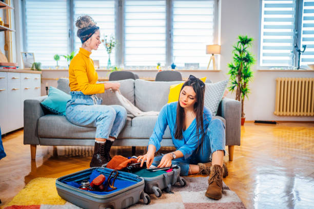 istock Women packing clothes in suitcase for travel 1384282113