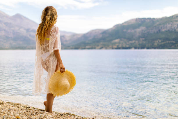 istock Amazing young woman enjoying alone on beautiful beach 1384283394