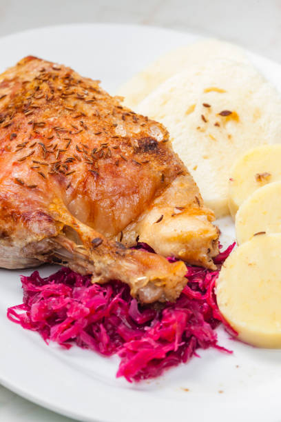roasted goose leg with red cabbage and dumplings
