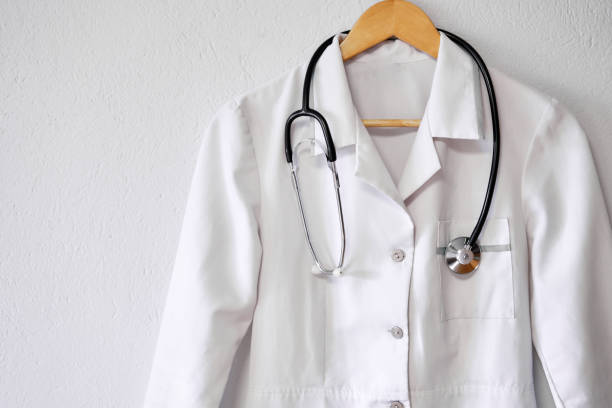 istock Doctor's white coat with stethoscope over white background with copy space. 1384288241