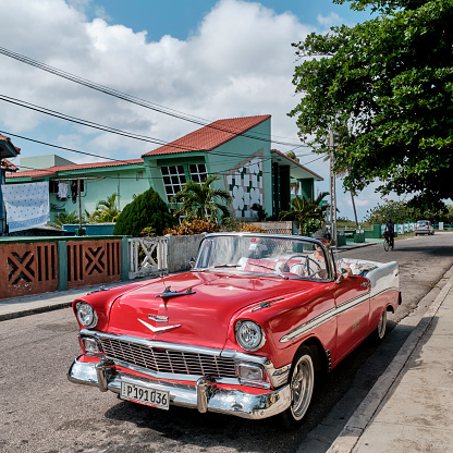 Varadero, Cuba - February 10, 2022: Red and white retro 1957 Chevrolet car on street of resort town. Transport concept