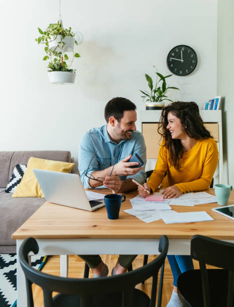 istock Happy Couple Paying Bills Together at Home 1384295144