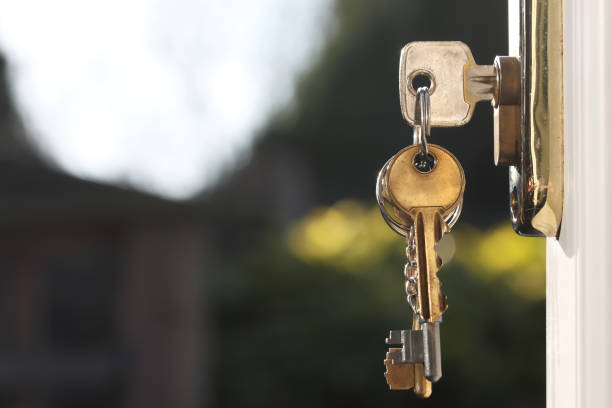 House keys in lock of a door viewed outside horizontal stock photo