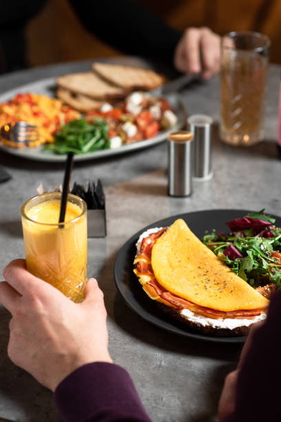 istock Man and woman eating an egg and bacon breakfast 1384302983