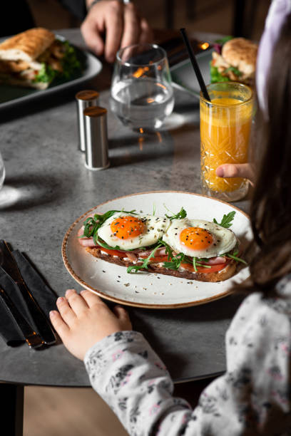 istock Breakfast toast with avocado, fried egg and sprouts 1384304401