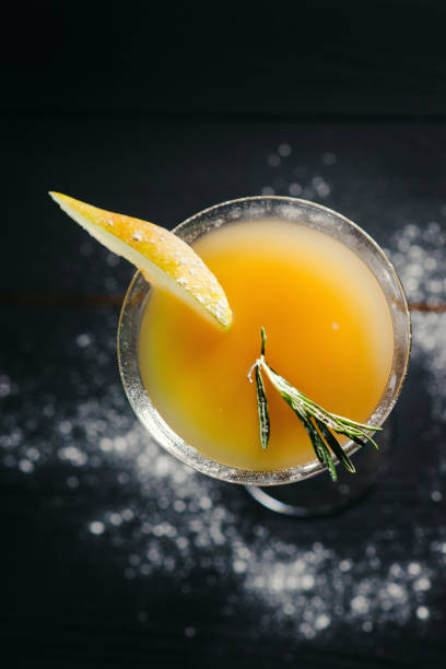istock yellow alcohol pear cocktail pear on dark background 1384304987