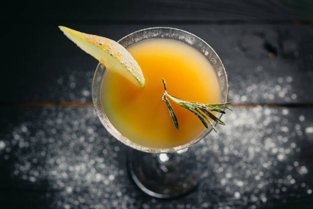 istock yellow alcohol pear cocktail pear on dark background 1384305018