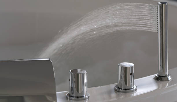 istock Water flows from a luxurious modern water faucet into a large modern bathtub. Spa, relaxation, hygiene concept 1384311754
