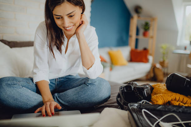 istock Young woman packing her suitcase for a trip 1384312033