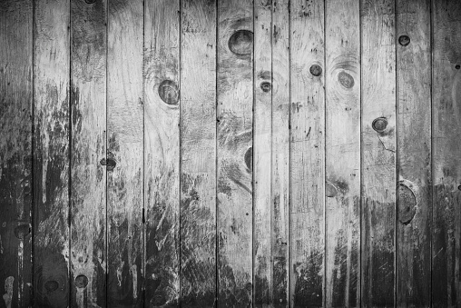 Old black and white wood planks background with chipping paint