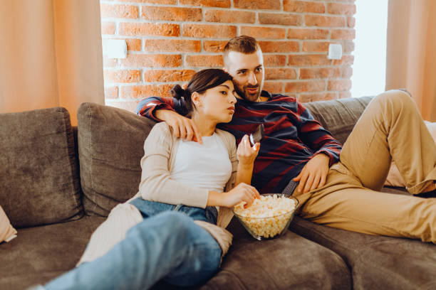 istock Young couple chill on the couch 1384318283