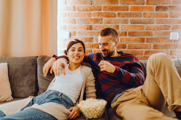 istock Young couple chill on the couch 1384318884