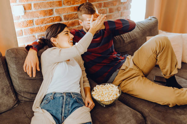 istock Young couple chill on the couch 1384318955
