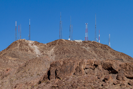 Henderson, NV, USA – February 17, 2022: Telecommunication radio and TV antenna towers on a mountain top in Henderson, Nevada.