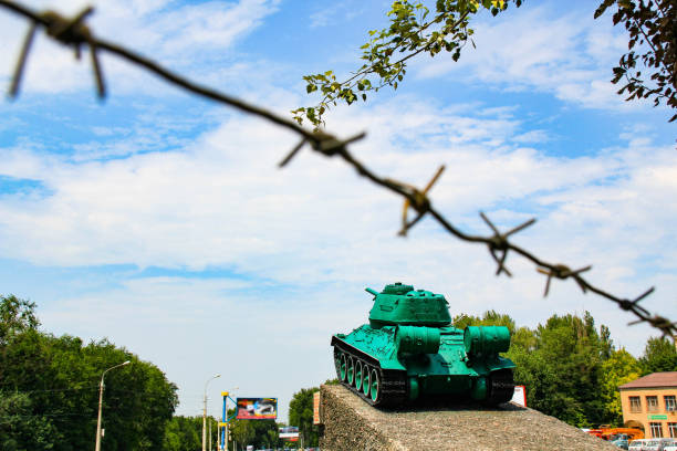 TIRASPOL, TRANSNISTRIA - CIRCA AUGUST 2016: A tank with the church. Tiraspol is the capital of Transnistria, a self governing territory not recognised by United Nations