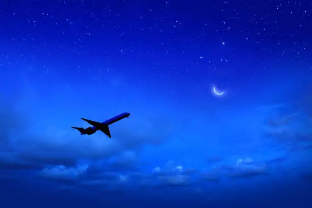 Photo of Commercial airplane flying at night sky