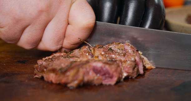 istock Chef Cutting a Medium Cooked Beef Looks Very Tasty 1384328561