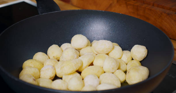istock Young Potatoes cooking in Pan. 1384328596
