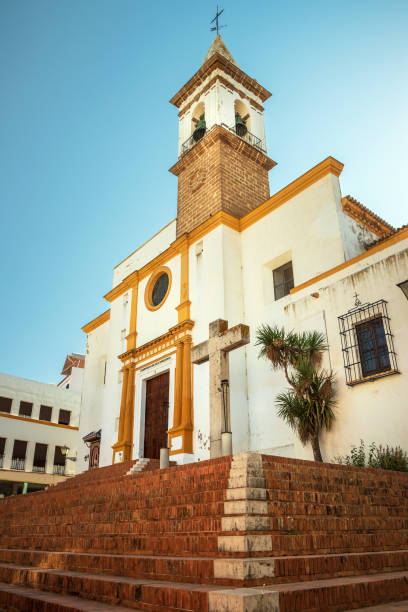 Beautiful main facade of the Iglesia de Nuestra Señora de las Angustias in Ayamonte, Spain, with the staircase in the foreground, on a sunny afternoon in summer. stock photo