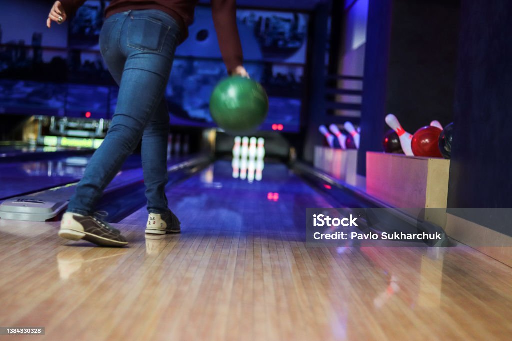 Woman in club for bowling is throwing ball Lawn Bowling Stock Photo