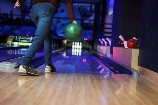 Photo of Woman in club for bowling is throwing ball