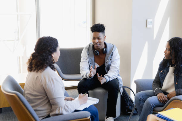 istock Young adult talks with counselor 1384332918