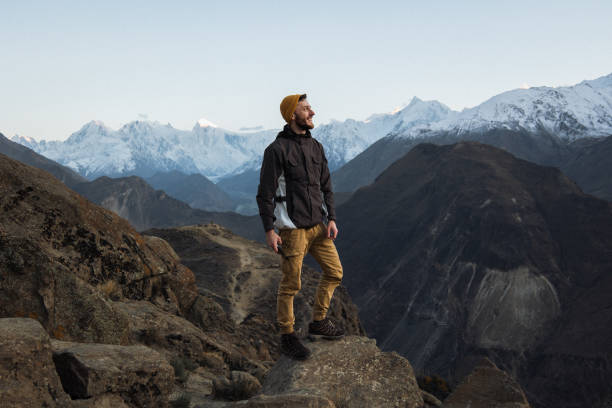 A young male traveler enjoy the sunset in Himalayas mountain
