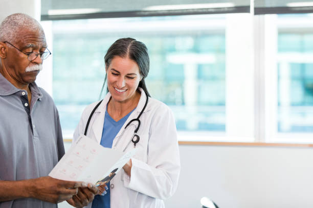 istock Senior man doubtful when doctor explains treatment options in brochure 1384333091