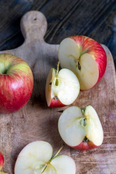 istock cutting old board with pieces of red ripe apple 1384333267