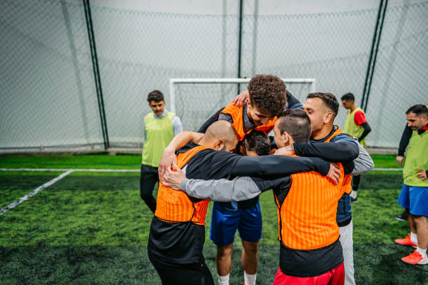 istock Soccer players celebrating victory 1384333892