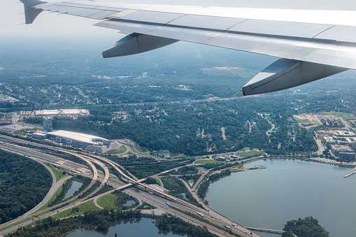 Plane aerial drone view of cityscape near Oxon Hill in Washington DC with i495 highway capital beltway outer loop with traffic cars and buildings