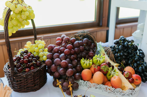 istock Different fresh fruits on wedding buffet table. Wedding reception catering table with different fruits. Catering table with different kind of fruits 1384336307