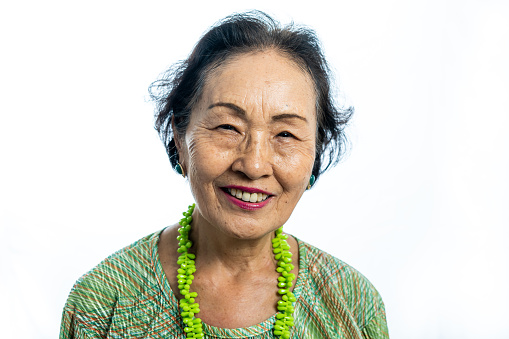 Portrait of a senior Japanese woman, white background