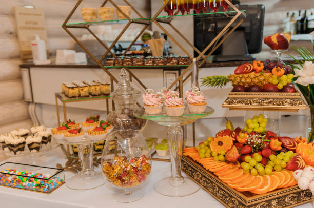 istock Different fresh fruits on wedding buffet table. Wedding reception catering table with different fruits. Catering table with different kind of fruits 1384336675