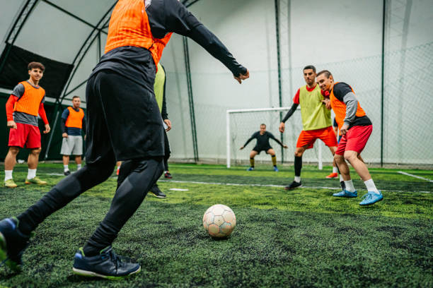 istock Soccer player kicking ball at goal 1384336876
