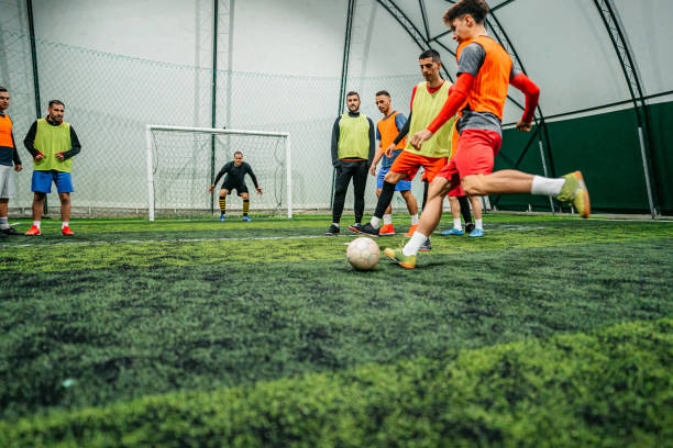 istock Soccer player kicking ball at goal 1384337559