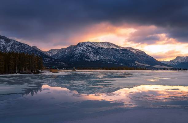 istock Sunrise And Mountain Reflections On A Canmore Lake 1384337705
