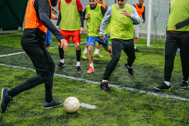 istock Soccer player kicking ball at goal 1384337866