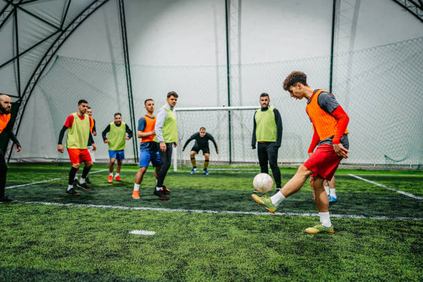 istock Soccer player kicking ball at goal 1384338010