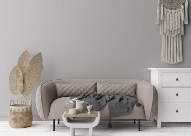 istock Empty gray wall in modern living room. Mock up interior in scandinavian, boho style. Free, copy space for your picture, text, or another design. Sofa, console, macrame, rattan basket. 3D rendering. 1384338393