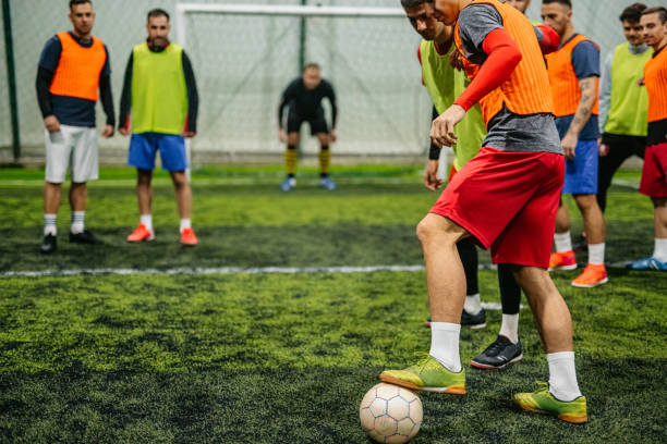 istock Soccer player dribbling ball on field 1384339318